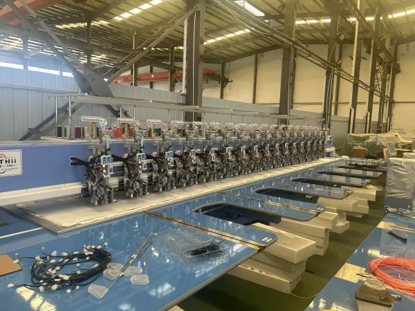 Embroidery machine with devices on the assembly floor