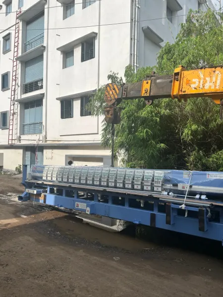 Crane unloading a machine